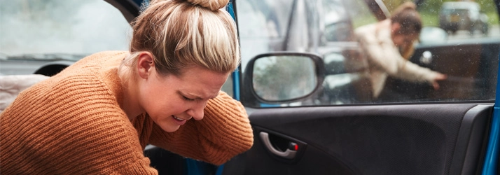 Chiropractic Maui HI Car Accident A woman holding her neck after a car accident.