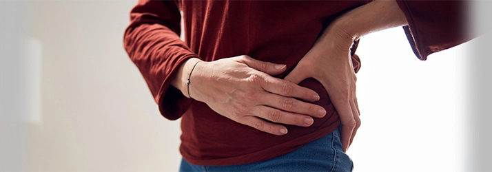 A person holding their hip.